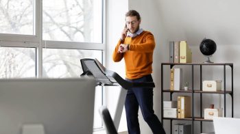 Office worker trying to get 10000 steps on treadmill resized e1653864716933 Do I Really Need 10000 Steps A Day?