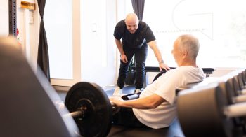 PT helps motivate client in the gym scaled e1673924260119 5 Ways to Revive Your Gym Motivation