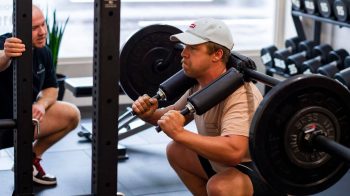 Plexus client warms up for squat session e1676349228967 How To Properly Warm Up Before Strength Training