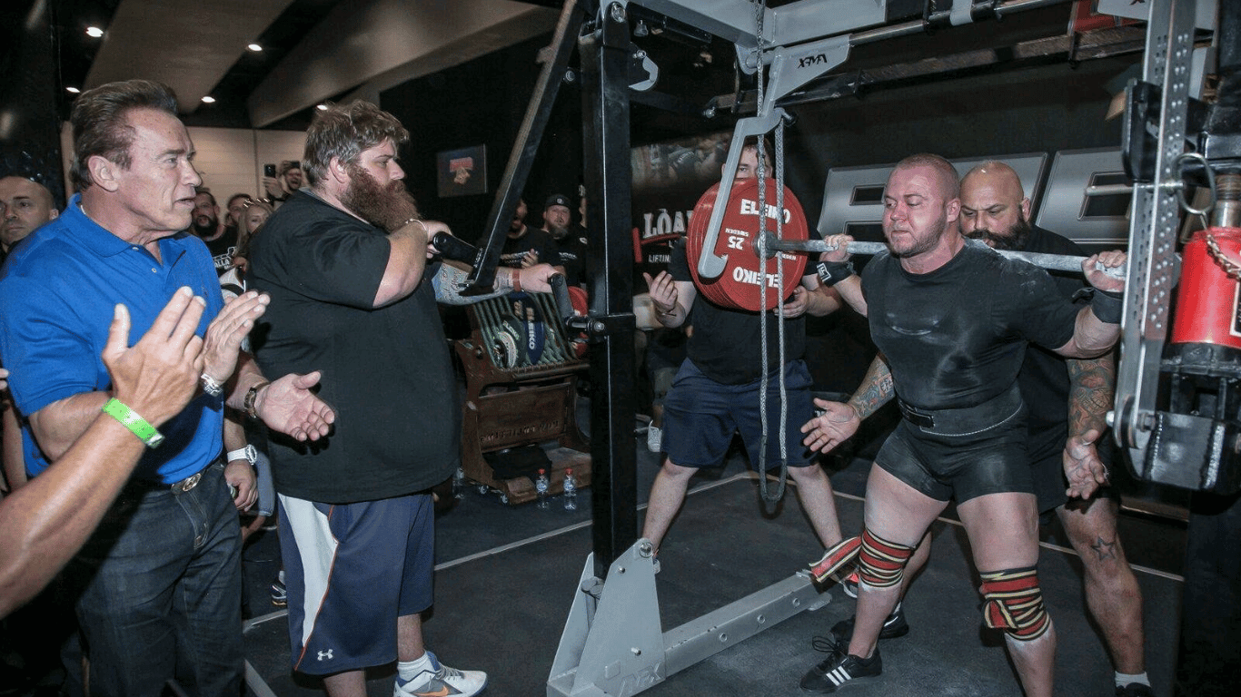 ben wright squatting 320kg at Pro Raw Powerlifting with Arnold Schwarzenegger.