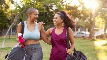 two ladies wearing workout clothes on their way to the gym